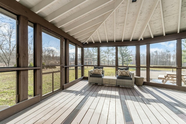 unfurnished sunroom featuring lofted ceiling