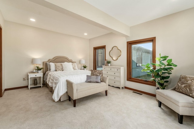 bedroom with light carpet and beamed ceiling