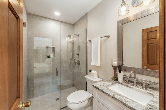 bathroom featuring vanity, toilet, and an enclosed shower