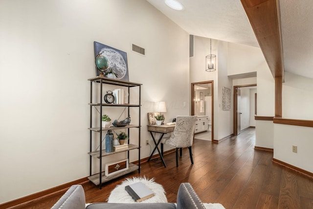 office featuring dark hardwood / wood-style flooring, high vaulted ceiling, and a textured ceiling