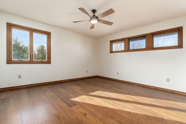 spare room featuring hardwood / wood-style flooring and ceiling fan