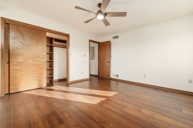 unfurnished bedroom with a closet, hardwood / wood-style flooring, and ceiling fan