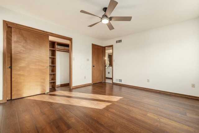 unfurnished bedroom featuring hardwood / wood-style flooring, ceiling fan, and a closet