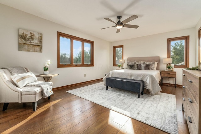 bedroom with multiple windows, ceiling fan, and dark wood-type flooring