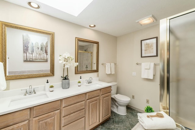 bathroom featuring tile patterned floors, vanity, toilet, and a shower with shower door