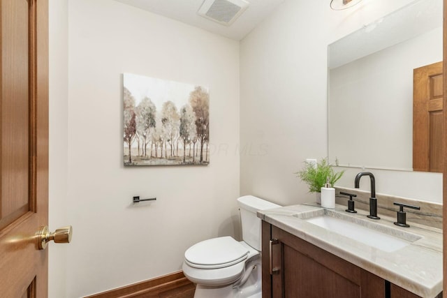 bathroom featuring vanity and toilet