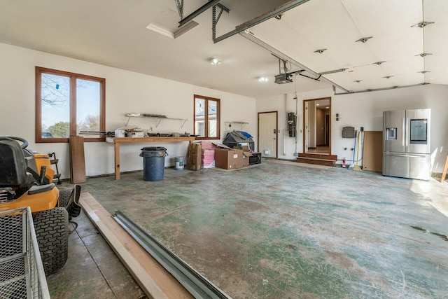 garage with electric panel, stainless steel fridge, and a garage door opener