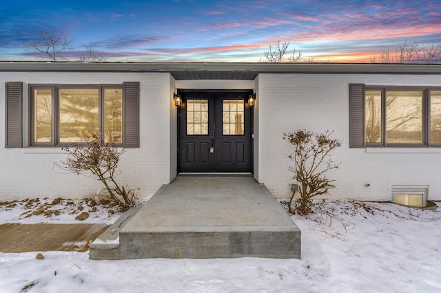 view of snow covered property entrance