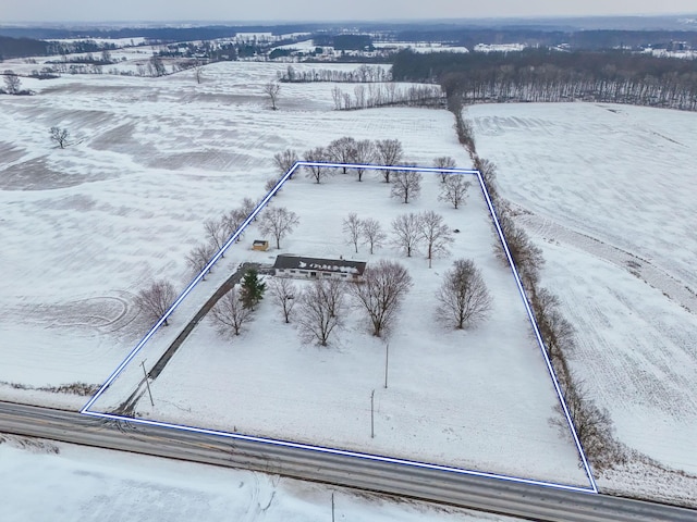 snowy aerial view featuring a rural view