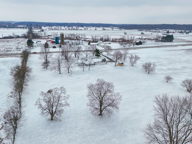 snowy aerial view featuring a rural view