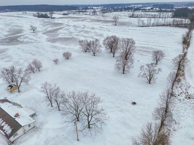 snowy aerial view featuring a rural view