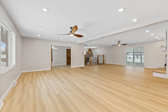 unfurnished living room featuring ceiling fan, light hardwood / wood-style floors, and a fireplace