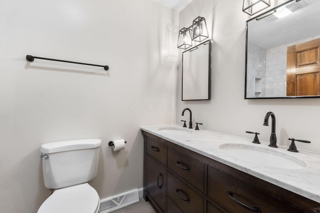 bathroom featuring vanity and toilet