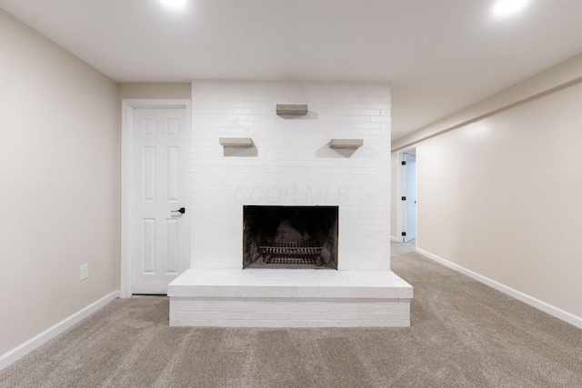 unfurnished living room with a fireplace and light colored carpet