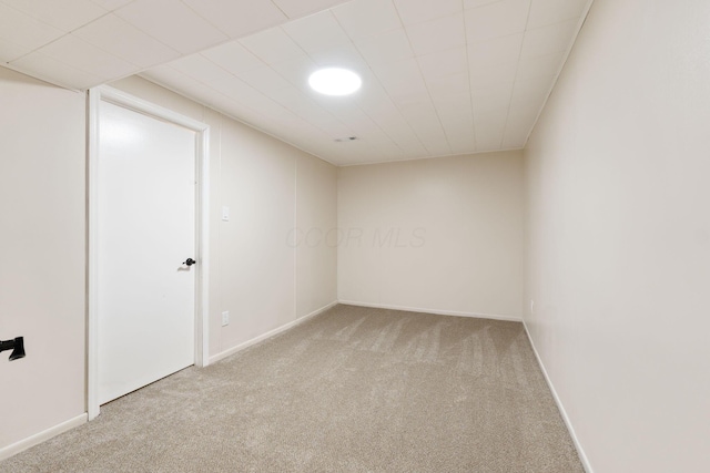 spare room featuring light colored carpet