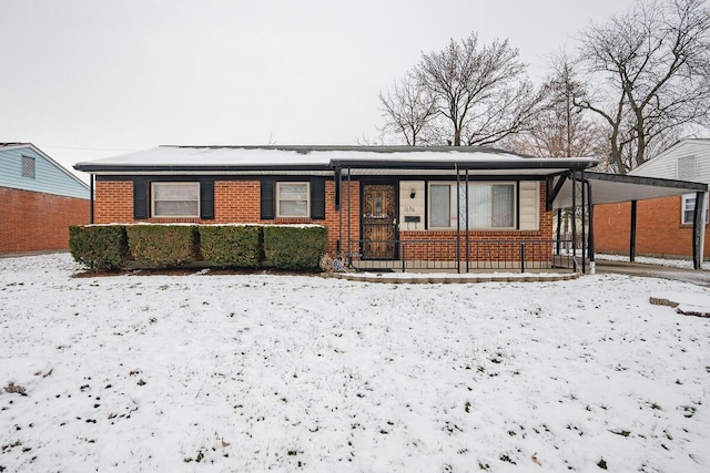 snow covered house with a carport