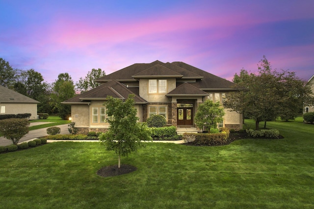 view of front of property with a lawn and french doors