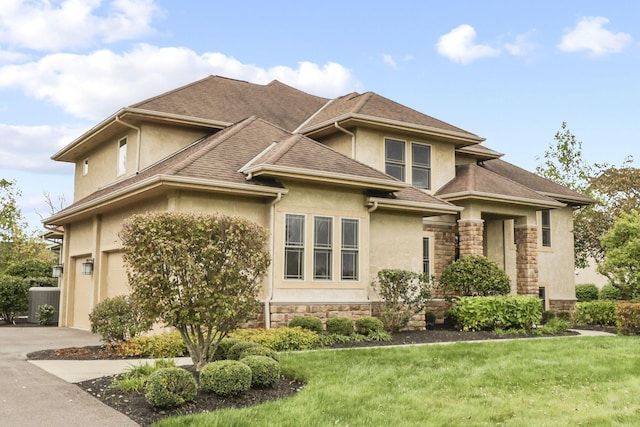 view of front of property with a garage and a front yard