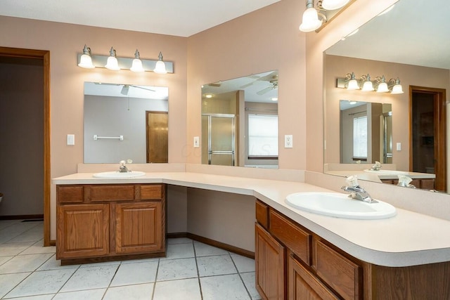 bathroom featuring tile patterned floors, ceiling fan, a shower with door, and vanity