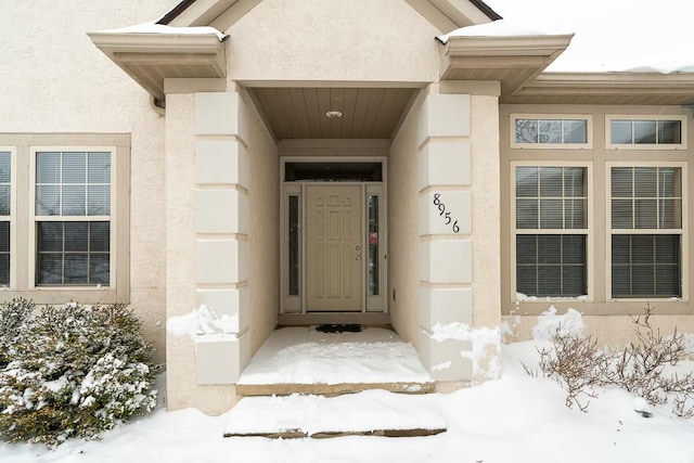 view of snow covered property entrance