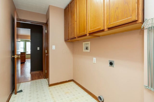 laundry area with electric dryer hookup, cabinets, and hookup for a washing machine