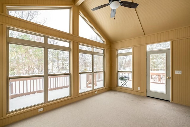 unfurnished sunroom with ceiling fan and vaulted ceiling