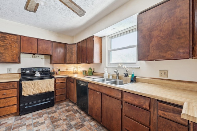 kitchen featuring sink, black appliances, and a textured ceiling