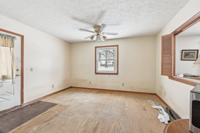 unfurnished room featuring hardwood / wood-style floors, a textured ceiling, and ceiling fan