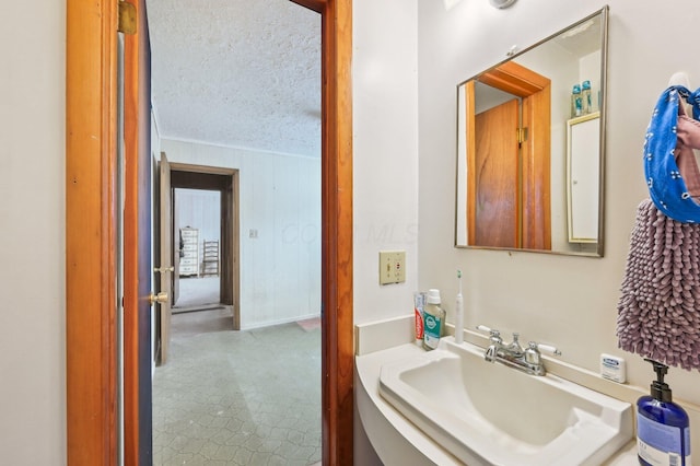 bathroom featuring sink and a textured ceiling