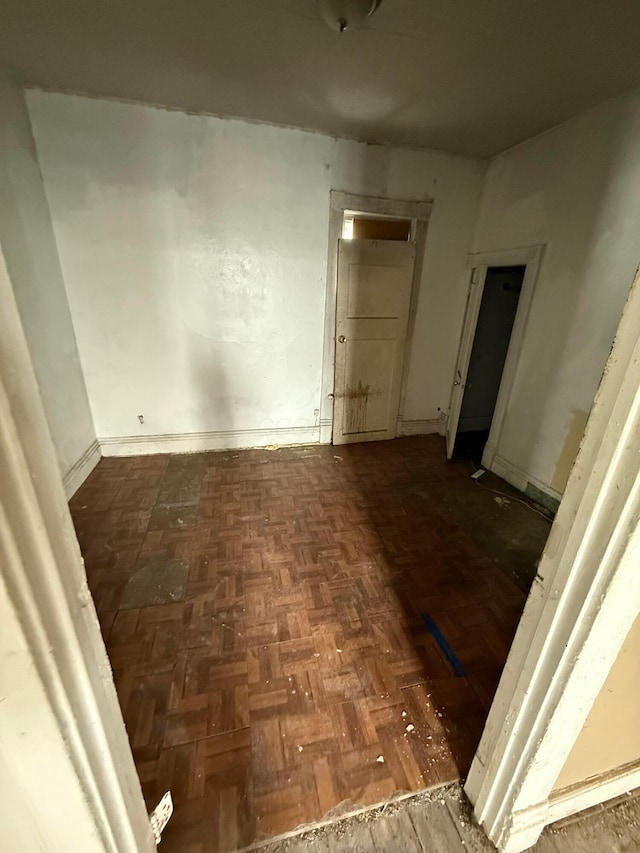 corridor featuring dark parquet flooring