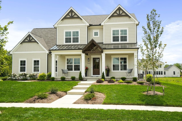 craftsman inspired home featuring a front lawn