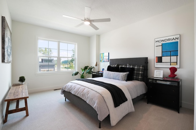 bedroom with light carpet and ceiling fan