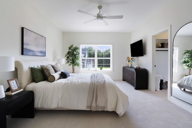 bedroom with light carpet and ceiling fan