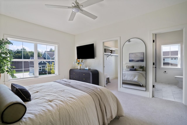 bedroom featuring connected bathroom and ceiling fan