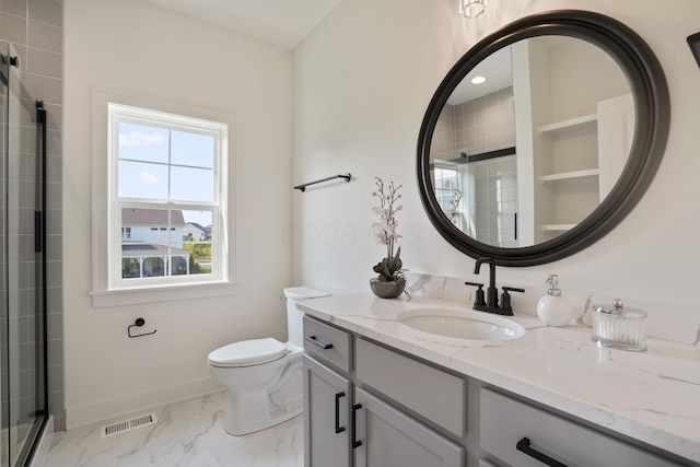 bathroom with vanity, an enclosed shower, and toilet