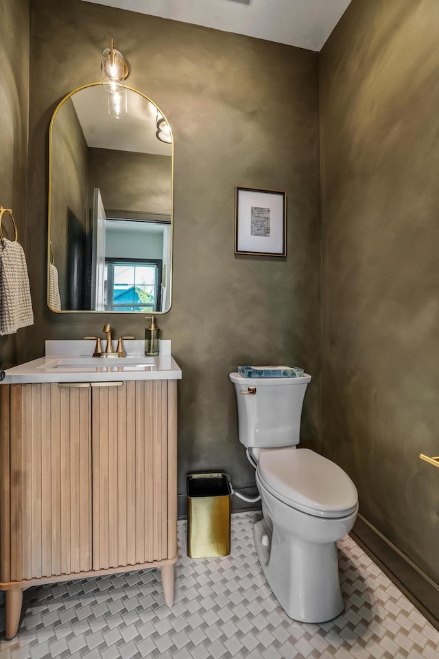 bathroom featuring tile patterned flooring, vanity, and toilet