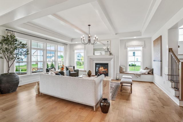 living room featuring a chandelier and light hardwood / wood-style floors