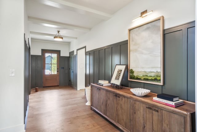 interior space with beamed ceiling and light hardwood / wood-style flooring