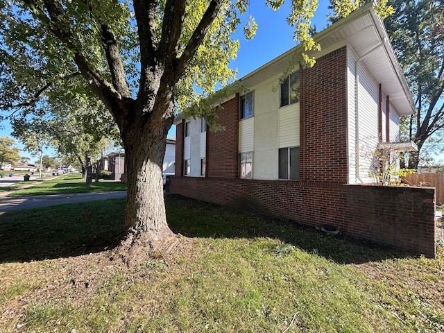 view of home's exterior with a yard