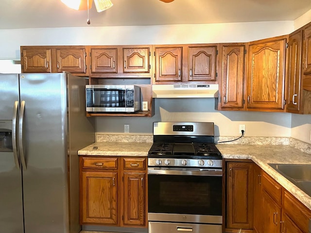 kitchen featuring ceiling fan, sink, and stainless steel appliances