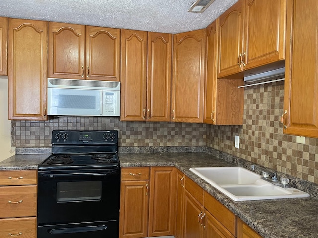 kitchen featuring a textured ceiling, black range with electric cooktop, tasteful backsplash, and sink