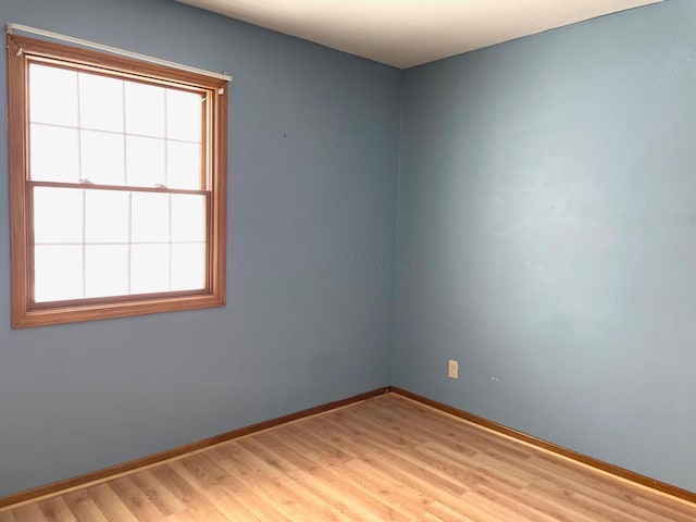 spare room with light hardwood / wood-style floors