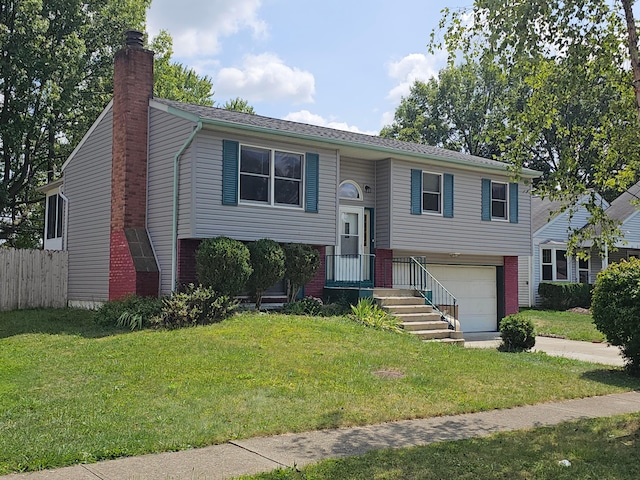 bi-level home featuring a front yard and a garage