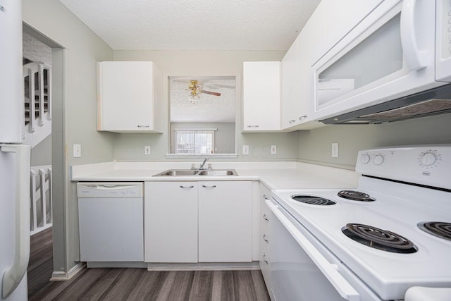 kitchen with a textured ceiling, white appliances, white cabinetry, and sink