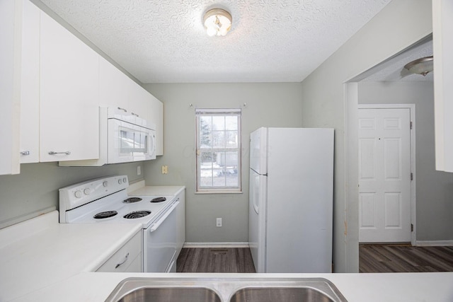 kitchen with white cabinets, white appliances, and a textured ceiling