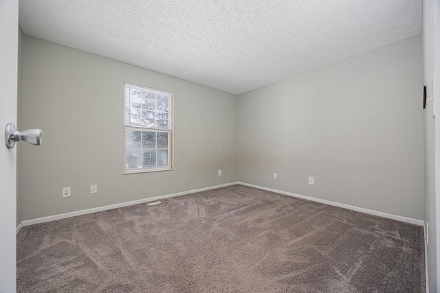 carpeted spare room with a textured ceiling