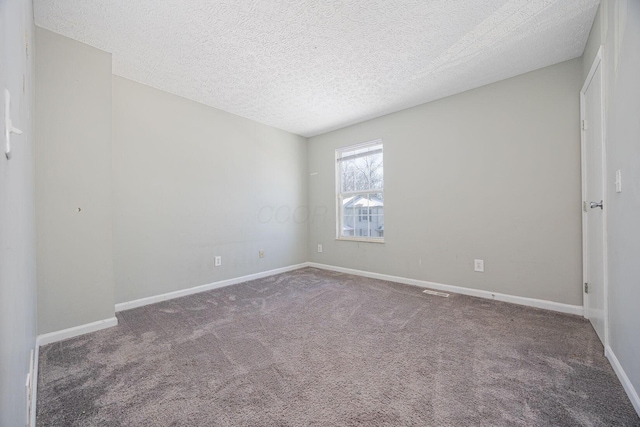 carpeted spare room featuring a textured ceiling