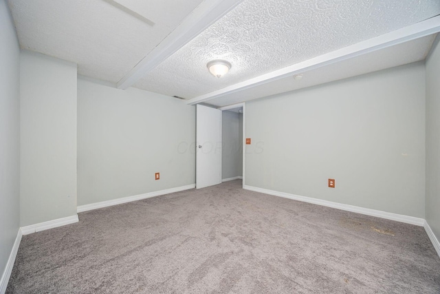 basement featuring carpet and a textured ceiling