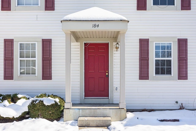 view of snow covered property entrance