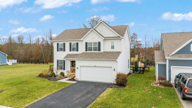 front facade featuring a garage and a front lawn